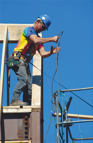 Man pulling scaffold cable